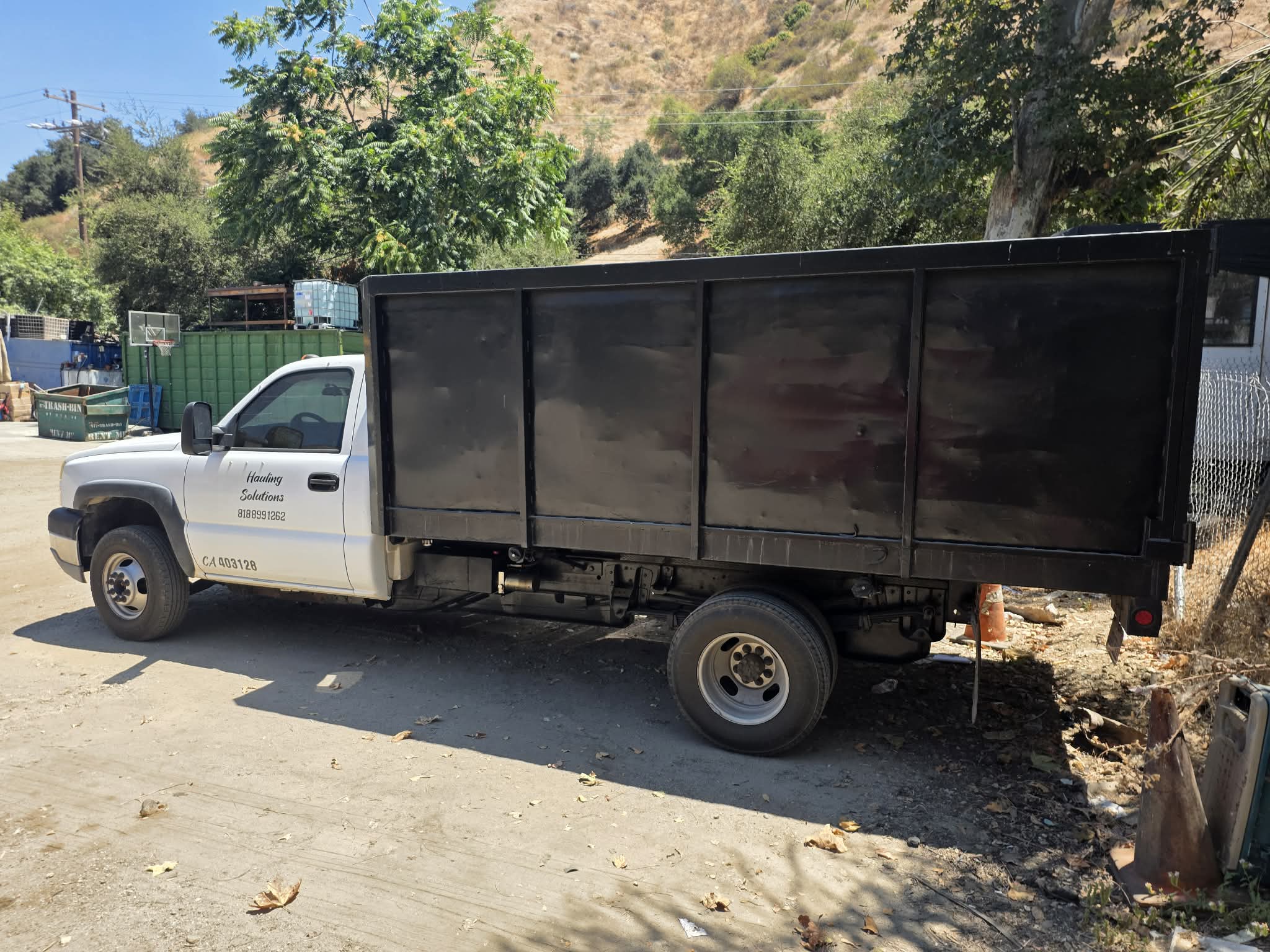 Tom's Dumpster Rental junk removal truck on the job
