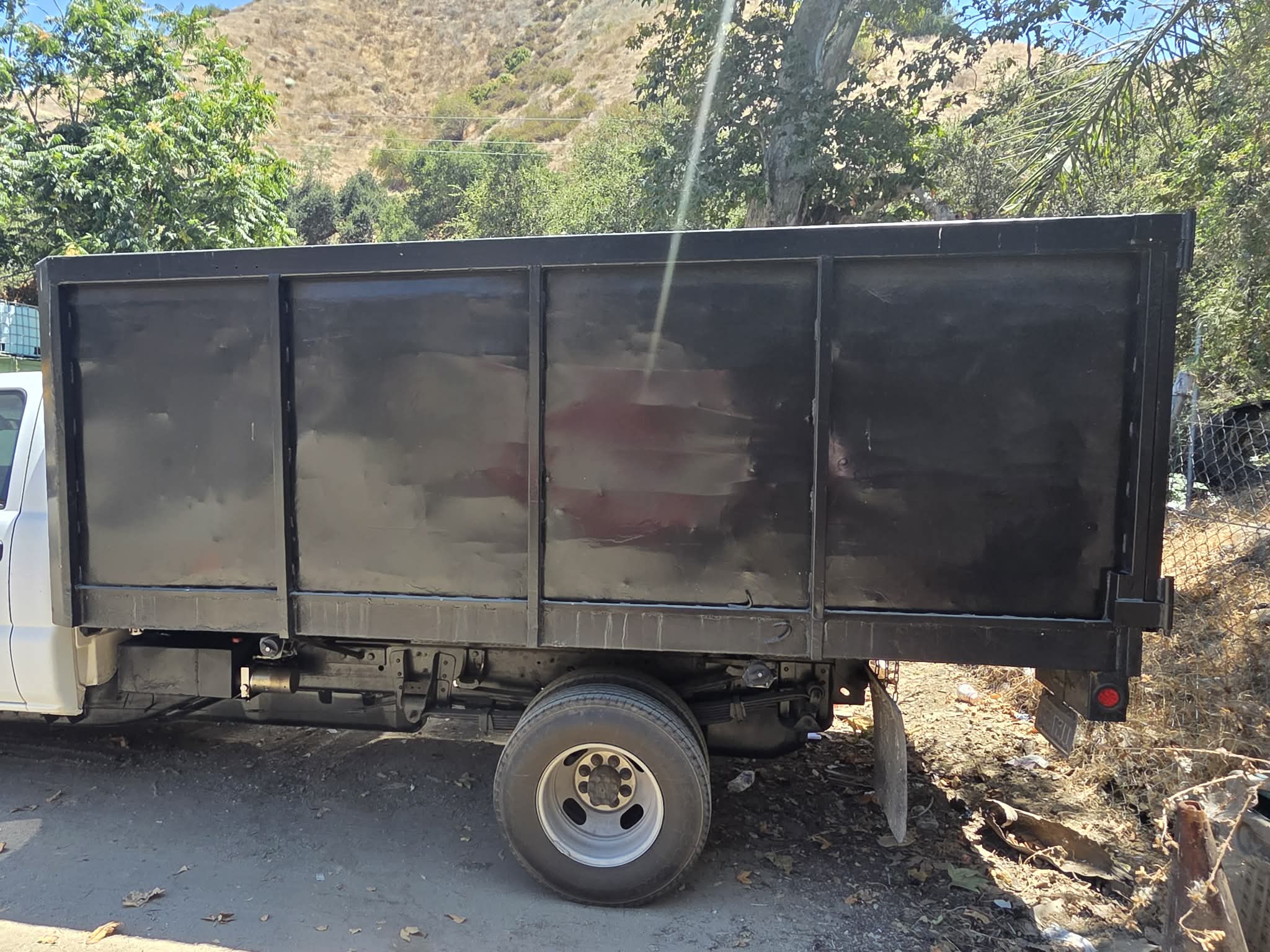 Tom's Dumpster Rental junk removal truck loaded